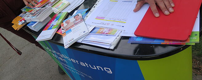 Stand der Bildungsberatung mit unterschiedlichen Foldern und Zetteln