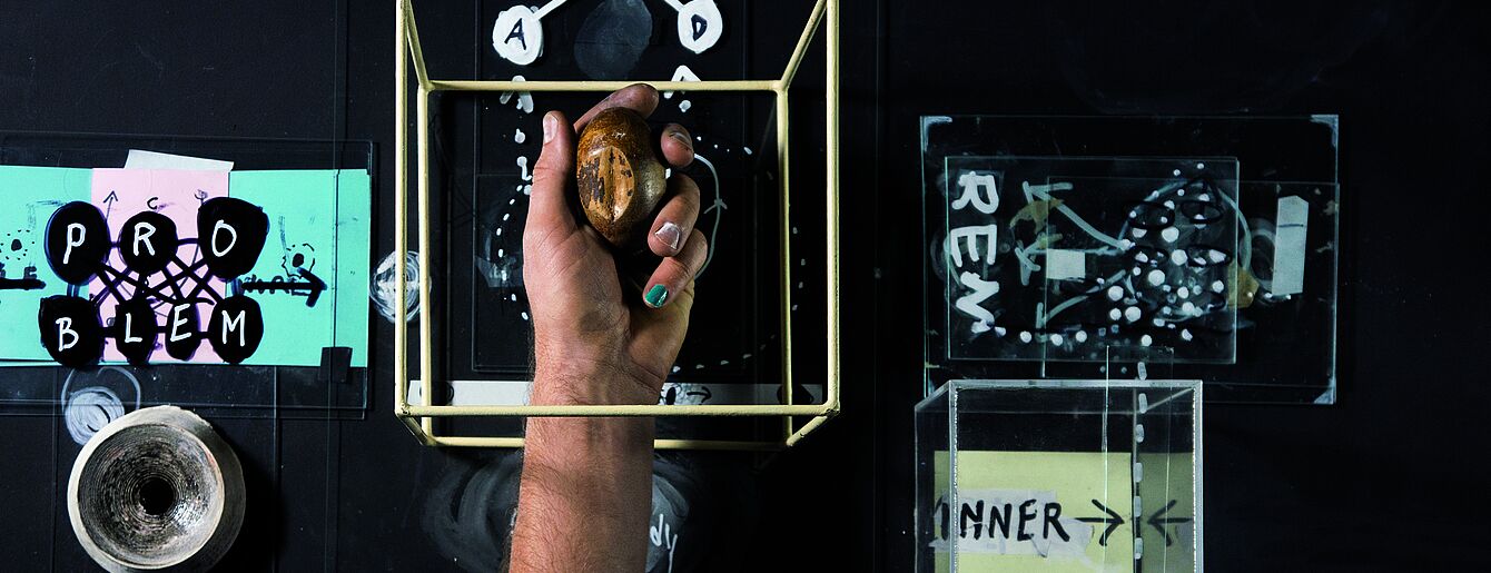 Eine Hand in einem Geflecht aus Zeichen und Formne