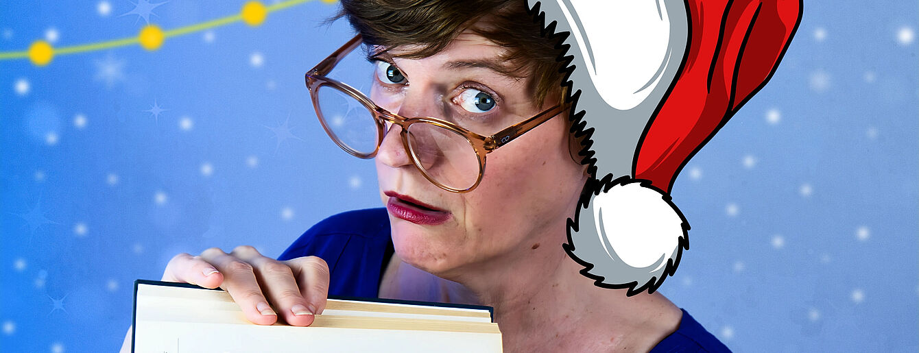 Person mit Brille und rotem Weihnachtsmütze blickt skeptisch über ein Buch hinweg